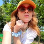 Angela Scanlon Instagram - The Unexpected Red Theory! It’s a thing apparently & sublimely or otherwise it’s been sticky. 1. A shiny red car I dream of and bag with charms 2. @myfrkl Pixelated heart 3. A red den 4. @tonygreen_illustration 🤠 cowboy hat (currently framing with red bobbles) 5. Old sunnies @maxandco (scrunchie @wearetbco ) 6. Dorothy shoes 7. @virginradiouk lift and Latin toes 8. Red fringe 👀 9. Red dots @14_day_manicure @secretspauk 10. Woman with travel blender Is it a thing?!