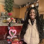 Aniela Gumbs Instagram - Hope you had a great Valentines Day 💕💕💕 I turned 15 and I’m old 😂 #anielagumbs hugs and kisses to you #kisses #chocolate #hugs #snuggles #zola #like #comment #follow #valentinesday #birthday #fit #cute #carnations #love