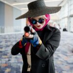 Anna Brisbin Instagram - Run, piggy, run! 💖 I’ve had every piece of this cosplay, including the painted gun, since early 2020. It was so nice to finally put it all on and go be a nerd at WonderCon again. 🥰 photo by @jameschatstv (silly edit by me lol) #harleyquinn #birdsofprey #wondercon #harleyquinncosplay #cosplay