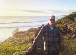 Annabeth Gish Instagram - Two decades ago today, we stood on the rugged and wild cliff-edge of the Sea Ranch Lodge to get married. The sky was exquisitely blue, the temperature a typical Northern Cali October brisk. Friends and family surrounded us, and we said things no one else could hear because the wind carried them out to the sea. Then we had the best party we’ve (still!) ever been to—though how is it our wonderful sons weren’t there!?! Twenty years later, to return and stand on the same ground is humbling. The elements have not changed in their persistence. The barn is more weathered, the coastline more ocean-carved, and windswept. Lol, so are we. Life works hard on us all. But what a brilliant adventure! What gratitude lives in our hearts. Happy Anniversary @donutshoppeproductions