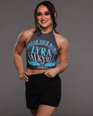 Aoife Cusack Instagram - First Lyra Valkyria shirt, available NOW on WWE shop! 🪶

@wweshop

📷@brutledge
💄@sgnicole