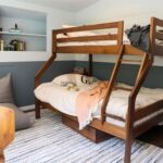 Ashley Williams Instagram - “My name’s Gus and I like small spaces,” my nine year old used to introduce himself to people this way. He loves reading, drawing, and “being cozy,” so when we considered designing a bedroom for him, the only answer was this mahogany treehouse vibe. We went to @roomandboard and had the best time designing exactly to his sensibility. He loves to sit at his desk and “imagine that I’m in the forest.” I’m obsessed with Room and Board’s sturdy, clean lined aesthetic and sometimes on stressful days I go hide in there myself. 😆 #homerenovation #kidsroom @we_are_kismet @alchemy_collective_ #roomreveal #ad