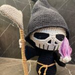 Athena Karkanis Instagram - Why do we fear death…? He’s adorable! Grim reaper pattern by @rokiki_ami. Purple fire was a special request. #crochetersofinstagram #amigurumi #amigurumist