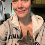 Bellamy Young Instagram - This made me smile, so I thought maybe it would you too...🥰 Made a cup of coffee & sat down to journal for a minute this morning. Razor was beside me as always, but my old man cat Button decided he wanted to be a part of the proceedings. He's gotten all sentimental in his old age & now does the sweetest things out of the blue. He jumped up in my lap, snuggled under my sweatshirt, popped his head out the top, & promptly fell asleep, his little purrs softly vibrating through me. 🥰 Hope you get some surprise love today too! I'm wishing you all the best! 🥰☕️📖😻❤️