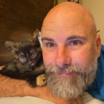 Briana Renee Instagram - Quinn (aka Mimi’s) is all about @manning_party_of_5 💜👉🏻 #catdad #purrfect #adoptdontshop #wrappedaroundherpaw 🐾 #catsofinstagram 🖤🧡 #bestillmyheart #sweetdreams