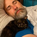 Briana Renee Instagram - Quinn (aka Mimi’s) is all about @manning_party_of_5 💜👉🏻 #catdad #purrfect #adoptdontshop #wrappedaroundherpaw 🐾 #catsofinstagram 🖤🧡 #bestillmyheart #sweetdreams