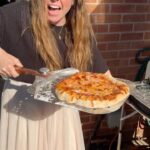 Briony May Williams Instagram – We’ve just got back from Italy and are missing the epic pizzas so we’ve been trying out our new @cuisinart_europe indoor pizza oven (we popped it outside as it’s a beautiful day!) on this glorious summer afternoon ❤️ It. Is. AMAZING!!! My bro went down to @thedoughkitchenbristol to get the delicious sourdough dough balls for the bases then we topped them and had crispy deliciousness in minutes!!! Thank you so much Cuisinart 🍕#gifted #giftedproduct #pizza #pizzaoven #homemadepizza