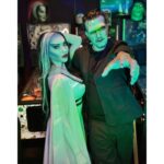 Carla Harvey Instagram – Happy Halloween from 1313 Mockingbird Lane 🎃 Channeling our inner Munsters 🖤We had so much fun recreating our favorite spooky couple last week with the help of @trooperhelmet 🧟‍♂️Swipe for all treats, no tricks 😜Thank you @cnelsonfx @nickmarrastudios @superstitchous_co #everydayishalloween #munsters #lilymunster #hermanmunster #yvonnedecarlo