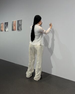 Carlota Guerrero Instagram - “Sofia Willendorf”
Silicon, hair and clay (2022) @staatsgaleriestuttgart #carlotaguerrero 

“An apparent visitor stands serenely in a corner of the exhibition room. She has her back turned to the rest of the viewers and looks down towards a small figurine she holds with one of her hands. 

Titled Sofia Willendorf, the installation takes the historian and anthropologist LeRoy McDermott and Catherine Hodge's thesis from their article Decolonizing Gender: Female Vision in the Upper Paleolithic (1996) as the starting point. In the text, the authors criticize the way the first images of human bodies, the Venus figurines, have generally been interpreted “as sex objects made from a male point of view”. Instead, they argue, they were made by women and for women  as a form of self-representation. Following this, the apparent distortions of the anatomy of the figurines become apt renderings if we consider the body as seen by a woman, presumably pregnant, looking down on herself.
 
Regardless of the veracity of the argument —which seems perfectly logical and credible— the question remains; why did it take so long to consider the logical possibility that a female point of view was involved?
 
Sofia Willendorf gives voice to that pregnant woman in the contemporary context, where past and present archetypes are confronted under the veil of an imposed male gaze the artist tries to subvert. A certain discomfort emerges while staring at the duo, ironically separated by 30,000 years gap. Originally purchased as a sex doll manufactured in China, the contemporary visitor cheerlessly exemplifies both the prevalence and the profound influence of the patriarchy."

text and curation
@marionavaldestorrella