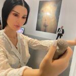 Carlota Guerrero Instagram - “Sofia Willendorf” Silicon, hair and clay (2022) @staatsgaleriestuttgart #carlotaguerrero “An apparent visitor stands serenely in a corner of the exhibition room. She has her back turned to the rest of the viewers and looks down towards a small figurine she holds with one of her hands. Titled Sofia Willendorf, the installation takes the historian and anthropologist LeRoy McDermott and Catherine Hodge's thesis from their article Decolonizing Gender: Female Vision in the Upper Paleolithic (1996) as the starting point. In the text, the authors criticize the way the first images of human bodies, the Venus figurines, have generally been interpreted “as sex objects made from a male point of view”. Instead, they argue, they were made by women and for women as a form of self-representation. Following this, the apparent distortions of the anatomy of the figurines become apt renderings if we consider the body as seen by a woman, presumably pregnant, looking down on herself. Regardless of the veracity of the argument —which seems perfectly logical and credible— the question remains; why did it take so long to consider the logical possibility that a female point of view was involved? Sofia Willendorf gives voice to that pregnant woman in the contemporary context, where past and present archetypes are confronted under the veil of an imposed male gaze the artist tries to subvert. A certain discomfort emerges while staring at the duo, ironically separated by 30,000 years gap. Originally purchased as a sex doll manufactured in China, the contemporary visitor cheerlessly exemplifies both the prevalence and the profound influence of the patriarchy." text and curation @marionavaldestorrella