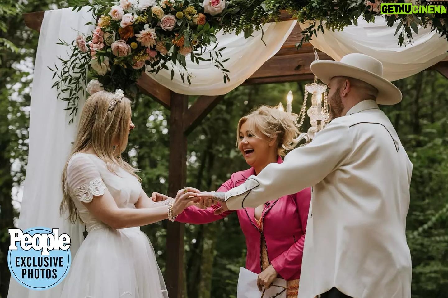 Caroline Rhea Instagram - You’re supposed to put a handful of rose petals in a little wooden box every time you have a “perfectly, lovely day” This was one of them. Getting to officiate the wedding of my beloved friends @forestblakk and his gorgeous wife @tooleyjones. No pressure to think of something to say in front of a poet and his muse. @forestblakk (CANADIAN) has 100 million streams on his songs. Sooo talented. They got married by a beautiful forest so when he walked down the aisle I actually got to say, “I can see the Forrest through the trees!” (What? I’m a comedian!) Tooley couldn’t have looked more beautiful. This might be the best perk I ever got from being #AuntHilda” Soul mates to family❤️ Wish the happy couple Congratulations @tooleyjones @forestblakk #weddingday #junewedding #love