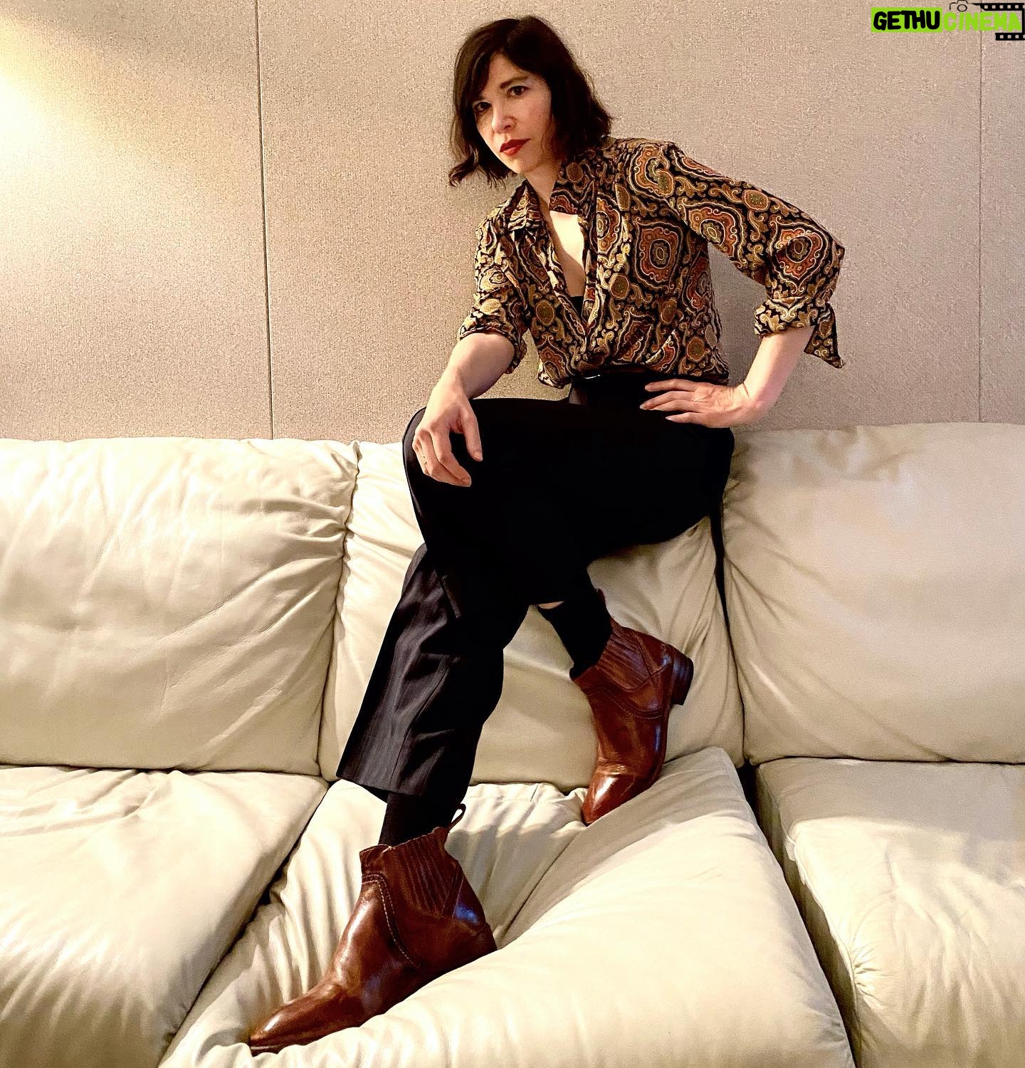 Carrie Brownstein - 20.2K Likes - Brown boots on white leather couch.