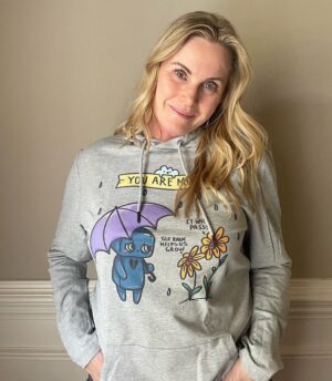 Catherine Sutherland Instagram - “It will pass” one of the most important affirmations we need to remind ourselves. It’s important to know that the storms in our lives are temporary and are meant to help us grow. 
The struggles we have with Mental Health are real. Your feelings are real. You are more capable than you could ever imagine. Keep fighting. ☔️🌻

Thank you to my friend @catherine_sutherland a superhero on the tv screen and in real life. She’s been a true supporter and believer along with @nakiaburrise on what we’re doing here. 💕

Hoodie designed and illustrated by @melotica.rt grab this design before we retire it this month. 

Link in bio

#mentalhealth #itwillpass #keepfighting #suicideprevention #depression #anxiety #youaremorethanenough #powerrangers #pinkpowerranger