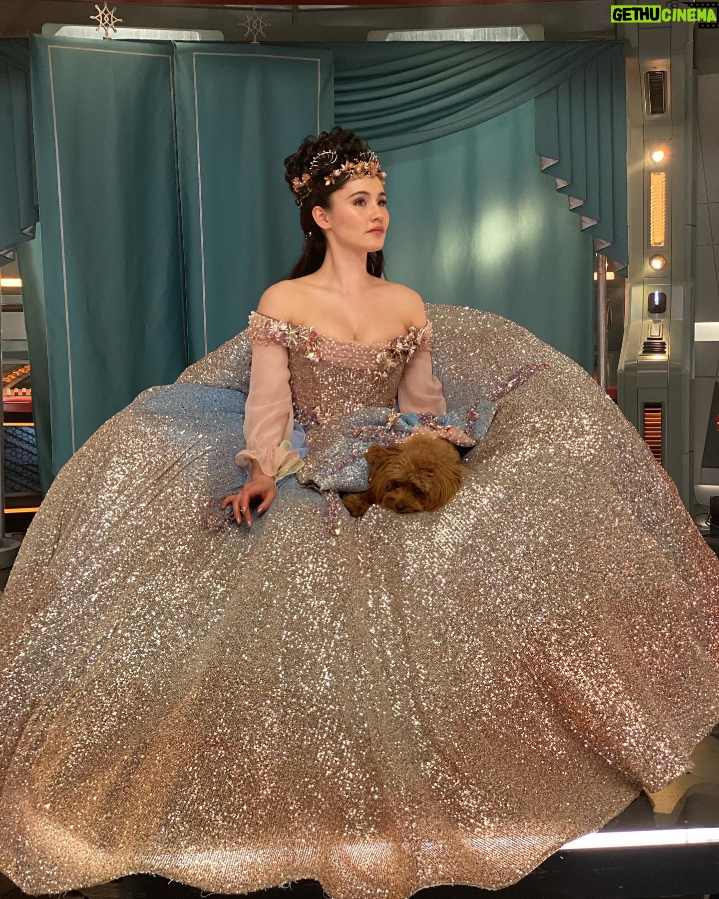 Christina Chong - 7.7K Likes - That Dress.
The memories of being in that dress will forever be some of my happiest 🥰
1. My reaction on seeing @rebeccaromijn in her fantasy costume!!
2. I couldn’t not do a slo-mo spin.
3. Quick spin for those who can’t be bothered to watch the slo-mo.
4. @runa_ewok and I in the Captain’s chair fantasy style.
5. The beautiful artwork design of both our costumes/the spin-off poster starring us both.
@berncroft and #sue you are the best!
#princessthalia #princessruna #SNW #strangenewworlds #puppy #dogsoftrek #cavapoo @startrekonpplus #startrek #bts