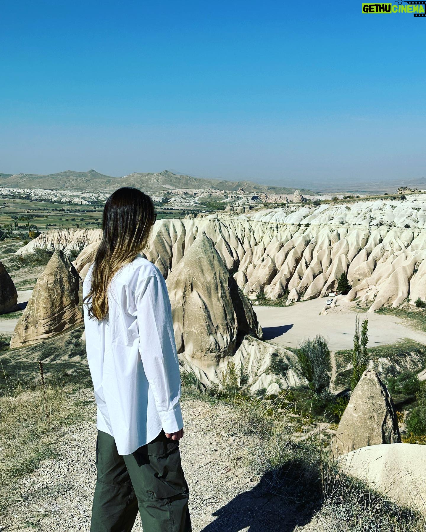 Clare Waight Keller Instagram - After Istanbul the valleys of Cappadocia - what I didn’t do was go in a balloon which is what most people do - what I did do was hike valleys and rocks and discover this incredible place on foot. 1. Gérôme National Park 2. See at the end the most remote cafe I’ve ever been to 3. Fall in the desert 4. Remote refreshments fresh pomegranate juice with a spectacular view 5. @uniqlo :C white shirt with @uniqlo U men’s cargo pants 6/7. Out in the valley 8/9 Room with a view at sunrise 10 The Chimneys #travel #memories #inspiration #turkey #cappadocia #remote #life #restaurant #goals