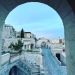 Clare Waight Keller Instagram - After Istanbul the valleys of Cappadocia - what I didn’t do was go in a balloon which is what most people do - what I did do was hike valleys and rocks and discover this incredible place on foot. 1. Gérôme National Park 2. See at the end the most remote cafe I’ve ever been to 3. Fall in the desert 4. Remote refreshments fresh pomegranate juice with a spectacular view 5. @uniqlo :C white shirt with @uniqlo U men’s cargo pants 6/7. Out in the valley 8/9 Room with a view at sunrise 10 The Chimneys #travel #memories #inspiration #turkey #cappadocia #remote #life #restaurant #goals