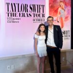 Clea Shearer Instagram - Stella and John at the premiere of The Eras Tour movie last week….posing with the photo John took for The Eras Tour movie. John earned a lot of points for take-your-daughter-to-work day. Stella’s priceless reaction when Taylor Swift walked into the room is on stories 💕