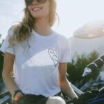 Cody Renee Cameron Instagram - Obsessed with women in the motorcycle community who support other women! @mrs_verhiel of @dellacrewco reached out to me 1 day and we had the loveliest convo about admiration, respect, & motorcycles. She said “I love what you’re doing how can I help?!” & I was blown away, because I thought, “GIRL, I love what YOU’RE doing SHEESH! What a BADASS! How can I be of service to YOU?!” She’s traveling around the world doing stunt shows & repping her dope motorcycle lifestyle clothing brand; I’m doubling for riders in tv shows and traveling around filming this motorcycle adventure show. We don’t see each other as adversaries, but rather as allies! She hooked me up with @mz.briwhite at @paradiseroadshow to snap some photos rocking her apparel and of course I was happy to oblige! I figure anyone she’s working with has to be just as cool & of course turns out Bri is just as rad and talented and supportive and it blows my mind how the web of support grows if you’re just out there being authentic, and open-minded, and humble. Keep creating, keep being kind, & the universe will open up to you! ❤️⚡️💀 and go check out @dellacrewco gear!!! 😎 Also rockin’ my @shewolfmotoco hat- another badass motorcycle ridin’ lady out here making the world a better place! 😻 Photocred @mz.briwhite Event @paradiseroadshow