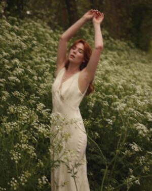 Courtney Halverson Instagram - “I always prefer wildflowers.” 
“I suspected as much.” 💐 

My love of wildflowers and of spring and Jane Austen and romance and Beatrix Potter and The Secret Garden and of antiques and of film scores and far too many other things to name all stems (pun intended) from my mother who raised me with all of the above. Thank you for instilling in me a love of all of this so early on. I am who I am this day because of you. 

And if you happen to recognize the quote here you very likely are similar, so maybe we grew up loving the same things. 🌿
.
.
.
#romanticstyle #cinematicmoments #wildflowers #ialwayspreferwildflowers #vintagevibes 
.
.
Wearing a dress from @rixo paired with beautiful clips from @eponavalley 🌿 lip color is banquette from @iliabeauty