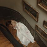 Courtney Halverson Instagram - At this hearing, I stand before my fellow members of the Tortured Poets Department with a summary of my findings. 🗝️🥀 ✉️ Forever a bleeding heart romantic, forever choosing the most heart-wrenching songs & poems & movies, and forever a little bit dramatic, so this felt like a fitting moment. Captured this drama on the staircase of the house we’re staying in in Paris and you better believe I will be listening to ttpd on the metro today. Are you listening too? . . . #ttpd #thetorturedpoetsdepartment #romanticstyle #paris #feminineenergy | wearing @milla at a @onefinestay property.