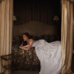 Courtney Halverson Instagram - I had a box of costumes as a child, and it was easily my favorite activity. Old scarves became skirts, tied haphazardly around my waist, a scrap of fur salvaged from a vintage coat acted as a stole draped across my shoulders, and a patterned blanket was transformed in my eyes to a cape. With this box of odds and ends, I found it easy picture characters (each a little extravagant) off on some grand adventure. I craved a world of fantasy - which if I think about it I suppose that’s in some way how I’ve ended up here. Creating photos and cinematic moments that each feel like their own little world, where I can (in a different way) play a character. And while some of my imagination has become reality, it’s nice to know that all these years later I can still drape myself in a sheet and make believe that it’s a ballgown. . . . #romanticstyle #elegantstyle #cinematic #feminineenergy . . Shot at the exquisite @ashfordcastle 🤍
