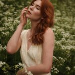 Courtney Halverson Instagram - “I always prefer wildflowers.” “I suspected as much.” 💐 My love of wildflowers and of spring and Jane Austen and romance and Beatrix Potter and The Secret Garden and of antiques and of film scores and far too many other things to name all stems (pun intended) from my mother who raised me with all of the above. Thank you for instilling in me a love of all of this so early on. I am who I am this day because of you. And if you happen to recognize the quote here you very likely are similar, so maybe we grew up loving the same things. 🌿 . . . #romanticstyle #cinematicmoments #wildflowers #ialwayspreferwildflowers #vintagevibes . . Wearing a dress from @rixo paired with beautiful clips from @eponavalley 🌿 lip color is banquette from @iliabeauty