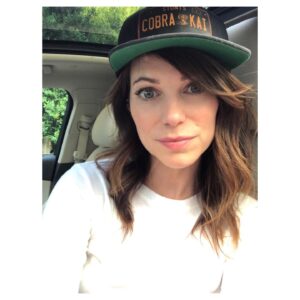 Courtney Henggeler Instagram - Sometimes I like to start my week by shuffling around Whole Foods with @cobrakaiseries gear, trying to incite violent, produce aisle karate battles. Or conversation. Honestly either way I consider it time well spent. 

Then of course, get in my car and take a dead serious selfie about it. 
🥬🌶🍉🍍🥦
