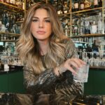 Daisy Fuentes Instagram - Getting through the Holidays… 🍸🎄 @daisyfuentesstyle Glam top & Earrings ✨🎄✨ @belvederevodka