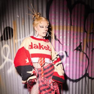 Dakota Schiffer Instagram - 011: pretty in punk
‘❤️dakota x winona 💜’

hand knitted jumpers- @winona.schiffer 
skirts- @rowcreativestudio 
hair- @mizvaseline 
photo- @amarriedcouple 

THE jumper!! A Marc Jacobs Heaven meets Vivienne Westwood fusion was our interpretation of the punk theme! This was my most sentimental runway look and of course it was one of the last runway categories! Winona painstakingly hand knitted this jumper for me while also writing her own dissertation and dealing will all my copious pre drag race meltdowns and last minute decision making. Not getting to wear this on the runway was the most heartbreaking aspect of being eliminated, so as soon as I was, I ran to go put it on so the world got to see the weeks and weeks of work that went into this look! Winona made herself a matching jumper to go with mine over the summer and I couldn’t be more pleased with how these looks turned out! 💜❤️