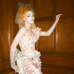 Dakota Schiffer Instagram – 006: The Mane Event, Love your hair hope you win!
“curtain call”

wig- @wigchapel 
film- @llyr.evans 
dress- @ros.ette 
embellishment- @4bihaywood and myself! 

This look is so special to me. My twin and I had our femininity policed massively growing up and had all our “girl” toys taken from us along with being told to change the way we talked walked and dressed by our family. After this our Grandma, who used to sneak dolls for us from the charity shop she worked at, let us play with the curtain tassels in her house and pretend that they were our hair. She never questioned our femininity and was one of the first family members who let us know it was ok to be feminine so to turn it around into a look was very emotional for me! This look is a love letter to anyone who had their femininity policed growing up. Even when we were being actively taught to be ashamed of the way we were naturally, it’s small moments like this from childhood that really stick with you. I know it’s silly but wearing curtain tassels on my head again was a very full circle moment! Reclaiming that femininity was so important for me to represent and I’d like to thank our Grandma for letting us be ourselves growing up! (and for also not getting angry at us when we took scissors to her curtain tassels!) 💖💖💖