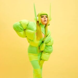 Dakota Schiffer Instagram - 004: Neon Nights
‘you are challenged by pokemon gym leader dakota’

dress & jacket- @thatsmarmalade 
photo- @amarriedcouple 
headphones- @winona.schiffer 
hair- me!

Imagine my horror reading the runway themes and seeing neon. Literally can’t think of anything less me, however I actually love this look we came up with. I wanted it to be very Alexa Demie for Balenciaga meets Elesa from Pokemon Black and White 2 and I think we came to a fab mix of references that I’m super happy with and allowed to sneak in my love of video games onto the runway! Thank you to everyone who made this look come together! 💚