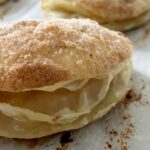 Damaris Phillips Instagram - Headed to see the #solareclispe tomorrow and thought these would be perfect for the drive!!!! Cinnamon Sugar Apple Turnovers Ingredients: 2 sheets of puff pastry, thawed according to package instructions 1 can (21 ounces) apple pie filling 1/4 cup granulated sugar 1 teaspoon ground cinnamon 1 egg, beaten (for egg wash) Instructions: Preheat your oven to 375°F (190°C) and line 2 baking sheets with parchment paper. In a small bowl, mix together the granulated sugar and ground cinnamon to create the cinnamon sugar mixture. Set aside. Roll out the thawed puff pastry on a lightly floured surface until it’s about 1/8 inch thick. Use a 4-inch round cookie cutter to cut out circles from the pastry. Spoon about 1-2 tablespoons of apple pie filling onto one half of each puff pastry circle, leaving a small border around the edges. Brush the edges of the pastry circles with the beaten egg. Fold the pastry over the filling to create half-moon shapes. Crimp the edges to seal the turnovers. Brush the tops of the turnovers with the beaten egg, then sprinkle generously with the cinnamon sugar mixture. Place the turnovers onto the prepared baking sheet, leaving space between each one to allow for expansion. Bake in the preheated oven for 20-25 minutes, or until the turnovers are golden brown and puffed up. Remove from the oven and let cool on a rack for a few minutes before serving.