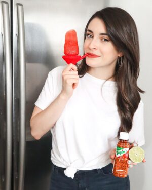 Daniela Bobadilla Instagram - This is what happens when a hungry Mexican girl is locked down and craving a summer treat... I told you! I put @tajinusa and lime on EVERYTHING 😂 ⁣
⁣
To celebrate the first week of summer, I’m sharing my healthy   refreshing popsicle recipes on the blog! LINK IN BIO. This is my Mexican Watermelon popsicle 🤤 ⁣
⁣
Also, can we talk about these genius no-mess popsicle holders?! Yes, that is a straw to sip the melted deliciousness as you go. Linked in post because everyone needs these. ⁣