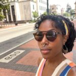 DeWanda Wise Instagram – Lately.

{De outside in a cute striped dress, shades, and earrings with her septum piercing in.

Bywater. 

A sign reads, “Beware of Ghosts.” 

My skincare routine is water, sunscreen, and minding the business that minds me.

Pizza that’s hilariously large to be on the kids menu.

A long hallway with her dog.}