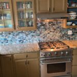 Dot-Marie Jones Instagram - I Retiled our backsplash @bridgettcjones found this beautiful glass tile! We love it so much!! Still need to wipe it down to get the grout glaze off so don’t look too close!