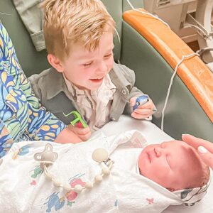 Elle Fowler Instagram - James meeting baby brother for the first time 🥰 James got to go to Chuck E Cheese for the first time while mama was in her surgery and is holding his prizes in his hands 😂