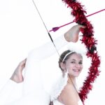 Emerald Gordon Wulf Instagram - Sending love to all of you with this little Valentine’s throwback! Happy Valentine’s Day! Photos by @kalialexsis outfit by @bluewaterdancewear #valentines #valentine #cupid #love #sweet #angel #flexible #flexibility #contortion #contortionist #heart #archery #bow #yoga