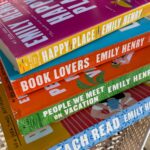 Emily Henry Instagram - We’re going back to the lake with Happy Place IN PAPERBACK! Available March 5, 2024 🩷🦞 Are you ready for it? #happyplace #beachread #berkleybookstagram #romancebookstagram