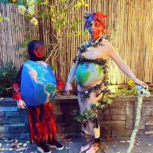Georgina Bloomberg Instagram - Half underwater, and half on fire, draped in items to represent the many ways I am slowly dying, and topped off with a necklace  made from rope and plastic we picked up from the beach this summer, my version of Mother Earth was an angry one this Halloween. And because there are very few things scarier… I brought my terrifying sidekick Global Warming along for the night. 🌍🔥☠️🌊