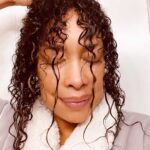 Gina Torres Instagram - Sharing a little self care moment…. Some of the amazing styles that @1nicnac creates for me on @911lonestar require a lot of smoothing and controlling products. You big hair & curly girls know it’s not about washing it out and styling everyday…. So midweek ~ to avoid too much buildup, I keep my crown protected and just give the perimeter some extra love and conditioning. Have you ever done this?? What’s your go to for hair care? Let’s share some tips!