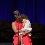 Heather Headley Instagram - A few weeks ago, I did a show at @atthemac, when I had a surprise, and incredibly cute visitor run out on stage to say hello to me. I traveled in that day for the show, and hadn’t seen much or enough of her. She asked her dad if she could come out and see me, and then proceeded to steal the show…and anything that was left of my heart. I asked her if she wanted to stay while I sang the next song which happened to be #WhenSheLovedMe (@randynewmanofficial, #ToyStory). It is now a moment that will stay sheltered in my mind and heart forever. A friend, who was there, snuck this picture and sent this to me, reminding me how much I love and miss her and our sons, and their amazing daddy…and just how blessed I am to be theirs. #mommydays #happysunday