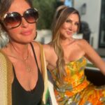 Heather McDonald Instagram - Slide Right. I Had a 1970 themed Palm Springs party last night. I got this dress b/c I knew it would pair perfectly with my sister’s. Shannon is wearing our mom’s dress from the early 1970s. How cute is my daughter in @trinaturk More pics and videos to come. No filter or photo shop on these FYI @goldstein.shannon @kraftmackncheese @deniseaustin @thebrandyhoward #palmsprings #laquinta #party #cocktails #pool #palmtrees #memorialday #1970s #eveningdress #juicyscoop #heathermcdonald @shophelsi is my dress