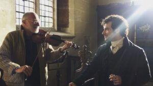 Heida Reed Instagram - Mike O'connor plays Aidan a familiar tune on set today.🎻 #poldark @official_poldark