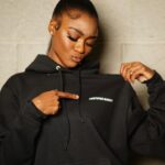 Imani Lewis Instagram - VERSATILITY🤌🏾🤍🖤🤍These unisex “Certified Bandit” Pullover Hoodies are SOOO comfortable and can be swagged so many different ways!! Which look do yall like better?!?👀🤍🖤Shop with the link in my bio!!🥷🏾 📸: @vp.trey