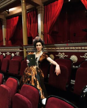 Imogen Heap Instagram - Here’s me holding the 150 year old programme from the first ever performance @royalalberthall we got from their archives. Using some of the words from that first ever performance I improvised a piece in the empty hall to celebrate their 150 year anniversary with a few people from the venue, Scout and some of my team in the ‘audience’. A far cry from the 8,000 people at the opening of the hall, special guest Queen Victoria. It airs tonight 7pm BST (link in bio) #rah150 

Dress by @viviennewestwood 
Wig by @wiginthecity