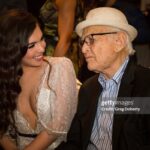Isabella Gómez Instagram - I like to think that I had a special bond with Norman, but I know hundreds of people feel that way. That’s just the kind of guy he was. He made you feel special, he made you feel seen. That’s what he did for millions around the globe, decade after decade. He changed the course of history and he changed my entire life. I am a better person for having known Norman Lear. I am more aware, curious, empathetic and am much more inclined to stand up and fight. Norman made me feel like I too could change the world. He made me feel like I was worthy of playing a character like Elena Alvarez. He made me feel like I was an important part of his legacy, his world altering legacy. I’ve heard dozens of people say this to Norman over the years and now I will say it and mean it as well: Norman, you raised me. To know you is not only to love you, but to be infinitely inspired by you. There are no words for the immense pride and gratitude I feel knowing I got to be on this earth at the same time as you and got to do what we both love most together. What a privilege. What an honor. Thank you for everything, especially for giving me a second family and leading us all so beautifully. Being your ‘newest daughter’ is my greatest accomplishment and I hope to carry you with me and live a life that would make you proud until we get to see each other again. I love you beyond the beyond. Wherever you are, I hope you’re better now, my sweet friend.