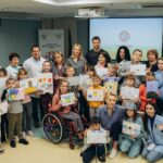 Ivanna Sakhno Instagram – “The heart beats in the rhythm of Ukraine” is written on the picture of Hryhoriy, a small patient of the Okhmatdyt hospital. He drew it together with our new ambassador, Ivanna Sakhno, who visited the injured children today.

“I learned a lot of painful stories experienced by children. But I also saw a lot of courage and willpower with which kids overcome difficulties,” Ivanna said.

Ivanna also took another picture painted for her as a gift. It depicts the Carpathians, where the actress’ mother is from. And the drawings she made with young patients will later be sent to schools in Ukraine rebuilt under UNITED24 with her help. 

Help our ambassador restore the school in Buzova village.

#united24 #thepoweroffreedom 

«Серце б’ється в ритмі України» написано на малюнку Григорія, маленького пацієнта лікарні «Охматдит». Він намалював його разом із нашою новою амбасадоркою Іванною Сахно, яка сьогодні завітала до поранених дітей. 

«Я дізналась безліч болісних історій, які пережила малеча. Але я також побачила багато відваги та сили волі, з якими діти долають труднощі», — поділилась враженнями Іванна. 

З собою Іванна забрала подарунок — картину, намальовану для неї. На полотні зображені Карпати, звідки родом мама акторки. А малюнки, які вона зробила разом з маленькими пацієнтами, згодом передадуть у відбудовані школи України. Адже саме ними опікується Іванна в межах співпраці з UNITED24. 

Допоможіть нашій амбасадорці швидше відбудувати школу в селі Бузова.
