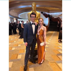 Jaime Ray Newman Instagram - Dreamy night at the Oscars with the hottest date on earth @guy_nattiv 🔥🧡💫

Thank you to THE GREATEST GLAM TEAM!

Stylist: @taraaquilinastyle 
Makeup: @beautyby_lana__ 
Hair: @michaelforrey 
Dress: @netaporter @galvanlondon 
Jewels & Purse: @alexisbittar 
Heels: @scarosso 
📸: @bucknerphoto 

Special shout out to THE BEST Grandma @madame_bob Auntie @bethnicolenewman and @robbygee212 who held down the fort while Ima & Aba had a much needed night out 🍑🧡