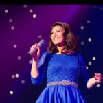 Jane McDonald Instagram - I first wore this gorgeous blue dress at my 2019 Christmas show. Designed by @kayheeley the dress has a nipped in waist and three-quarter length sleeves - a real classic! I can’t wait to share the outfits for my upcoming tour with you!