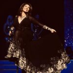 Jane McDonald Instagram - Loved this outfit, which I wore on my Making Memories tour. The dress had a gorgeous gold trim with a sexy black see-through mesh. Created by the talented @kayheeley - can’t wait to see all her designs for my 2024 tour! @angelcouturebykayheeley